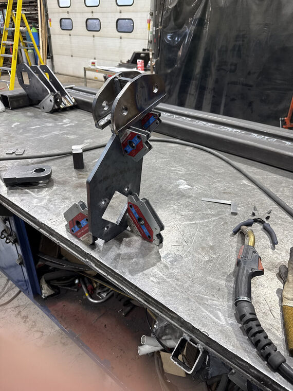 Fabricated pivot bracket assembly in welding jig